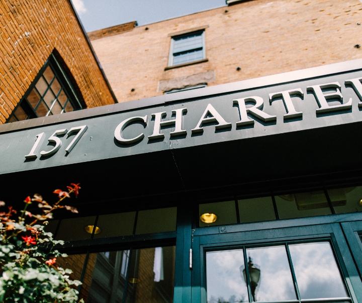 Image of the outside of a building with address listed (157 Charter St.)